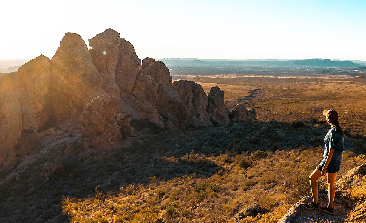 Hiker stands before a stunning New Mexico mountain range.
