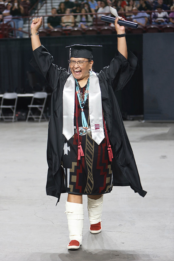 DACC student celebrating while graduating