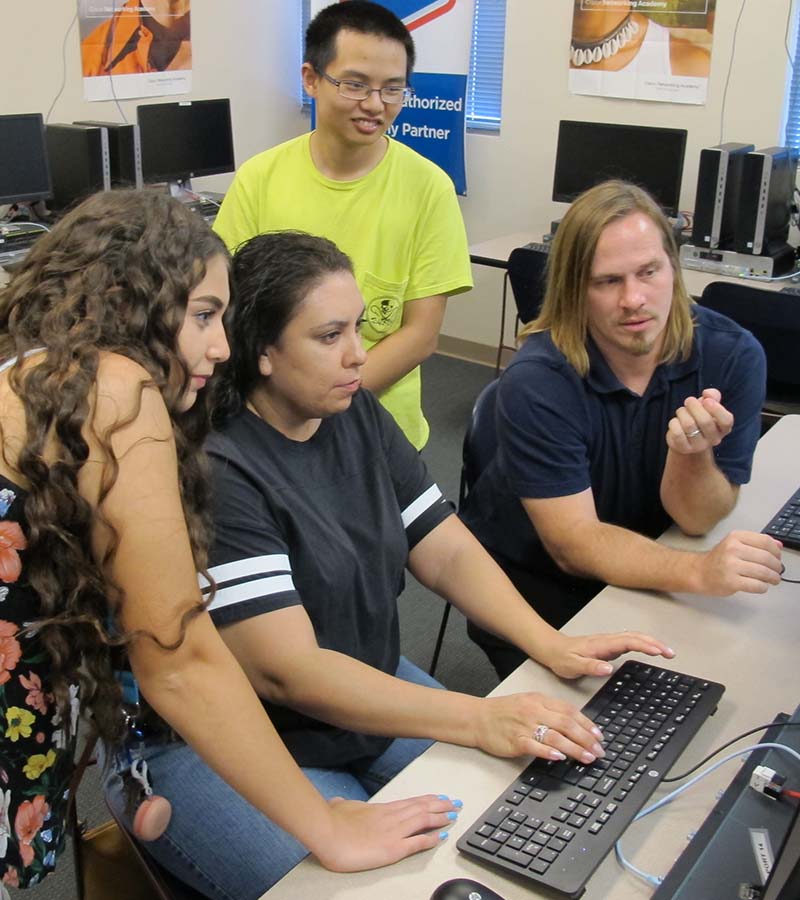 Students and instructors utilizing a computer.
