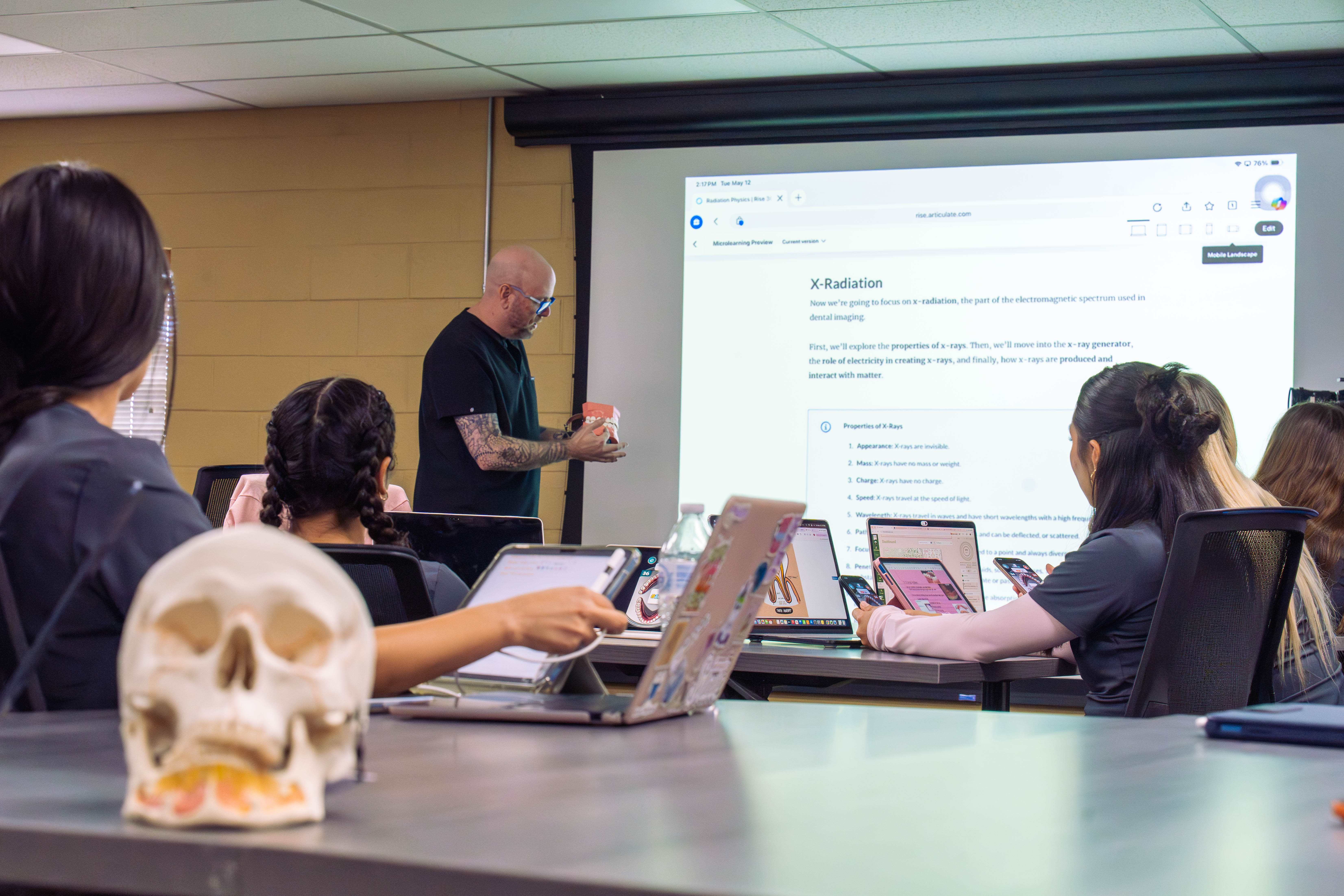 Students working in a dental class on app