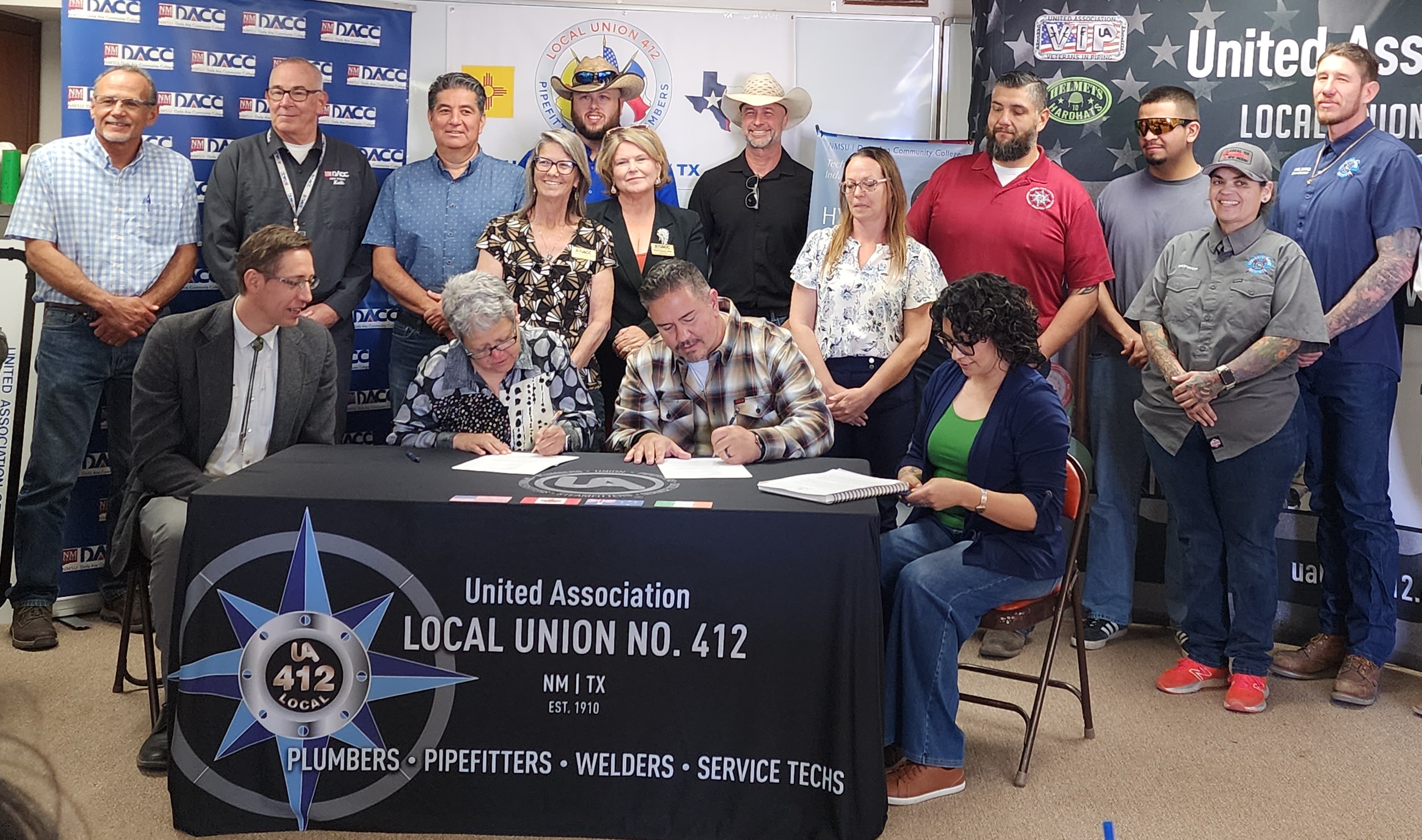 Members of DACC, state representatives and Union 412 sign a memorandum of understanding