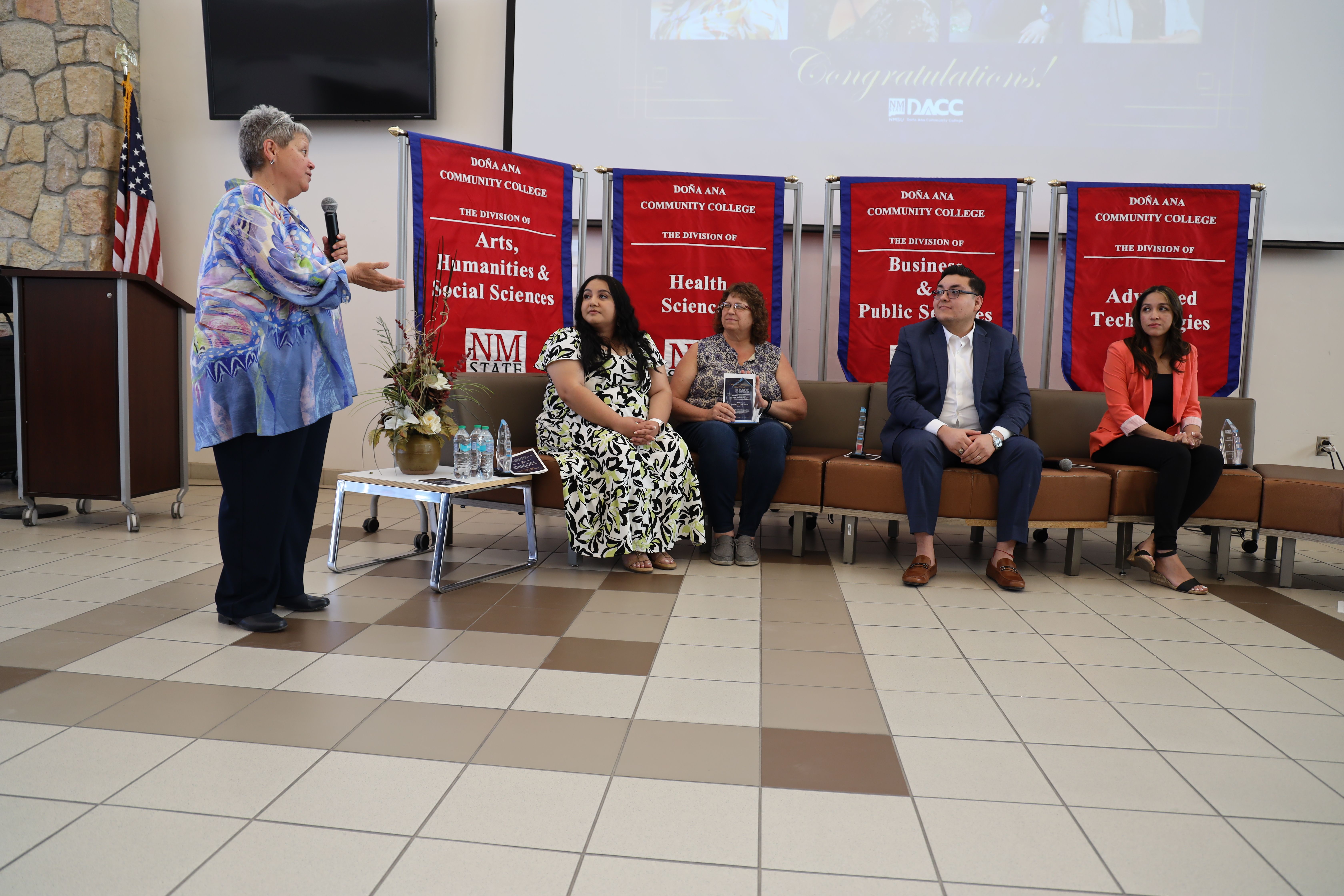 Dr. Mónica Torres, chancellor of DACC, speaks with the 2025 Distinguished Alumni recipients during the annual block party.  