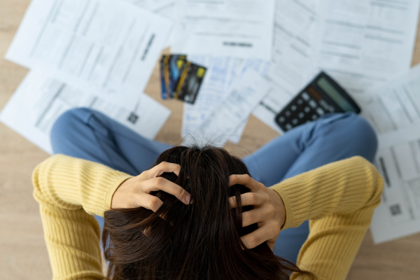 bills on floor, stressed student